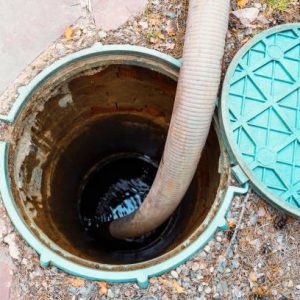 Pipe in the drainage pit. Pumping out sewage from a septic tank. Septic tank service